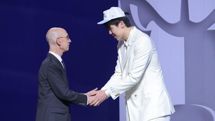 Jun 25, 2025; Brooklyn, NY, USA; Yang Hansen greets NBA commissioner Adam Silver after being selected as the 16th pick by the Memphis Grizzlies in the first round of the 2025 NBA Draft at Barclays Center. Mandatory Credit: Brad Penner-Imagn Images