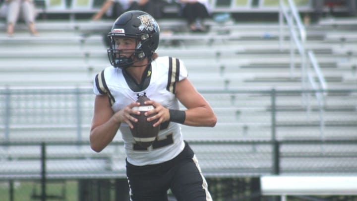 Buchholz quarterback Trace Johnson (12) rolls out to pass in warm-ups before a high school football game at Nease on September 30, 2024. [Clayton Freeman/Florida Times-Union]