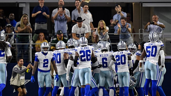 The Dallas Cowboys defense celebrates in front of the fans during the game against the Green Bay Packers