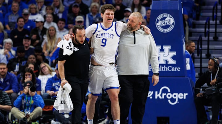 Nov 4, 2025; Lexington, Kentucky, USA; Kentucky Wildcats forward Trent Noah (9) is helped off the court during the first half against the Nicholls Colonels at Rupp Arena at Central Bank Center. Mandatory Credit: Jordan Prather-Imagn Images Nov 4, 2025; Lexington, Kentucky, USA; Kentucky Wildcats forward Trent Noah (9) is helped off the court during the first half against the Nicholls Colonels at Rupp Arena at Central Bank Center. Mandatory Credit: Jordan Prather-Imagn Images