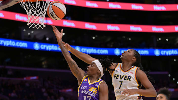 Los Angeles Sparks guard Erica Wheeler (17) drives past Indiana Fever center Aliyah Boston (7)