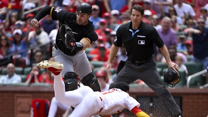 May 7, 2025; St. Louis, Missouri, USA;  St. Louis Cardinals center fielder Victor Scott II (11) slides safely past Pittsburgh Pirates catcher Joey Bart (14) to score during the third inning at Busch Stadium. Mandatory Credit: Jeff Curry-Imagn Images