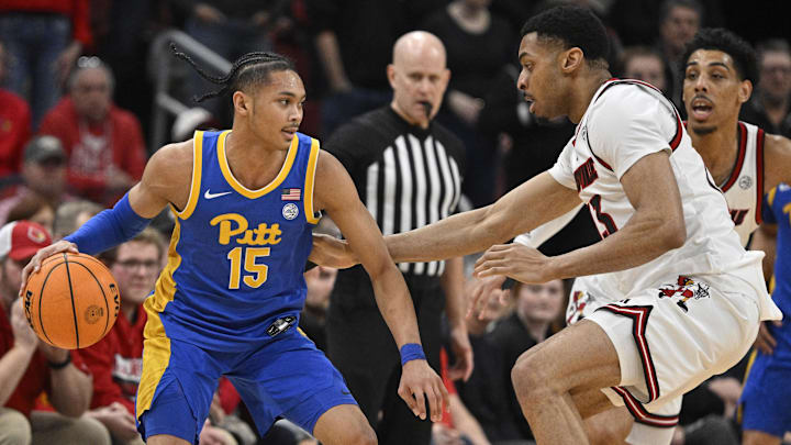Mar 1, 2025; Louisville, Kentucky, USA;  Pittsburgh Panthers guard Jaland Lowe (15) dribbles against Louisville Cardinals center Frank Anselem-Ibe (13) during the second half at KFC Yum! Center. Louisville defeated Pittsburgh 79-68. Mandatory Credit: Jamie Rhodes-Imagn Images