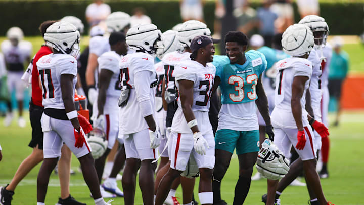 Aug 6, 2024; Miami Gardens, FL, USA; Miami Dolphins cornerback Siran Neal (33) talks to Atlanta Falcons safety Dane Cruikshank (31) during a joint practice at Baptist Health Training Complex. Mandatory Credit: Sam Navarro-USA TODAY Sports
