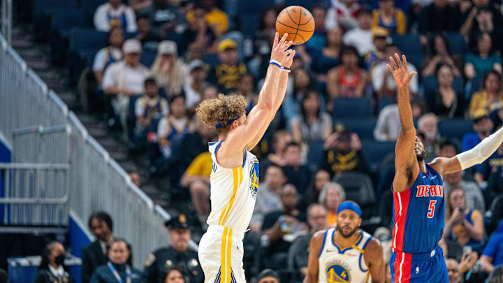 Oct 13, 2024; San Francisco, California, USA;  Golden State Warriors guard Brandin Podziemski (2) shoots a three point shot over Detroit Pistons guard Malik Beasley (5): Neville E. Guard-Imagn Images