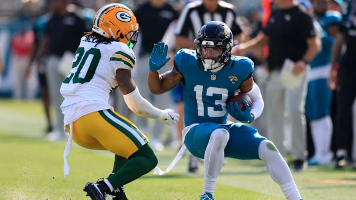 Jacksonville Jaguars wide receiver Christian Kirk (13) tries to manuver past Green Bay Packers safety Javon Bullard (20) during the third quarter of an NFL football matchup Sunday, Oct. 27, 2024 at EverBank Stadium in Jacksonville, Fla. The Packers edged the Jaguars 30-27 on a last-second field goal. [Corey Perrine/Florida Times-Union]