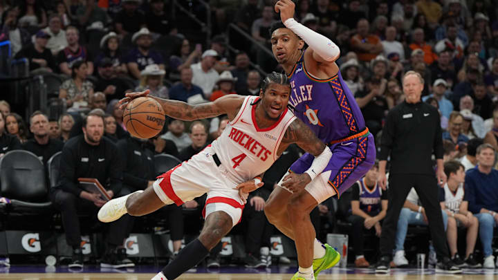 Mar 30, 2025; Phoenix, Arizona, USA; Houston Rockets guard Jalen Green (4) drives on Phoenix Suns forward Ryan Dunn (0) in the first half at Footprint Center. Mandatory Credit: Rick Scuteri-Imagn Images