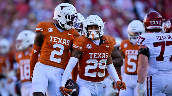 Oct 11, 2025; Dallas, Texas, USA; Texas Longhorns defensive back Derek Williams Jr. (2) and defensive back Graceson Littleton (29) celebrate after Littleton intercepts a pass from Oklahoma Sooners quarterback John Mateer (not pictured) during the second half at the Cotton Bowl. Mandatory Credit: Jerome Miron-Imagn Images