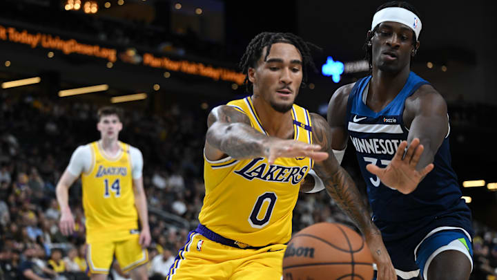 Los Angeles Lakers guard Jalen Hood-Schifino (0) tries to recover the ball against Minnesota Timberwolves forward Leonard Miller during the second half at Acrisure Arena in Palm Desert, Calif., on Oct. 4, 2024. Los Angeles Lakers guard Jalen Hood-Schifino (0) tries to recover the ball against Minnesota Timberwolves forward Leonard Miller during the second half at Acrisure Arena in Palm Desert, Calif., on Oct. 4, 2024.