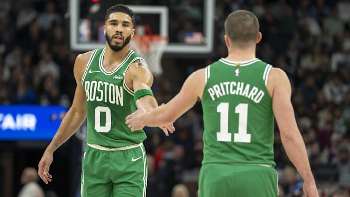 Jan 2, 2025; Minneapolis, Minnesota, USA: Boston Celtics forward Jayson Tatum (0) celebrates with guard Payton Pritchard (11) after making a shot against the Minnesota Timberwolves in the first half at Target Center. Mandatory Credit: Jesse Johnson-Imagn Images