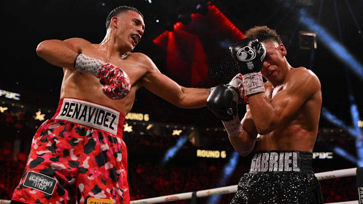 David Benavidez lands a left hook through the guard of David Morrell. David Benavidez lands a left hook through the guard of David Morrell.