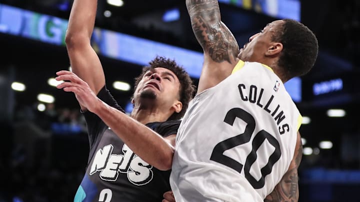 Jan 29, 2024; Brooklyn, New York, USA;  Brooklyn Nets forward Cameron Johnson (2) drives past Utah Jazz forward John Collins (20) in the third quarter at Barclays Center. Mandatory Credit: Wendell Cruz-Imagn Images