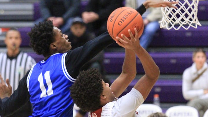 Newark's Braylon Morris attempts a layup against Richmond Heights' Dorian Jones during the Wildcats' 41-36 victory in the Five-C Classic at Capital University on Sunday, Dec. 22, 2024. Newark's Braylon Morris attempts a layup against Richmond Heights' Dorian Jones during the Wildcats' 41-36 victory in the Five-C Classic at Capital University on Sunday, Dec. 22, 2024.