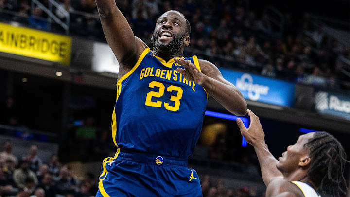 Feb 8, 2024; Indianapolis, Indiana, USA; Golden State Warriors forward Draymond Green (23) shoots the ball while Indiana Pacers guard Bennedict Mathurin (00) defends in the first half at Gainbridge Fieldhouse. Mandatory Credit: Trevor Ruszkowski-Imagn Images