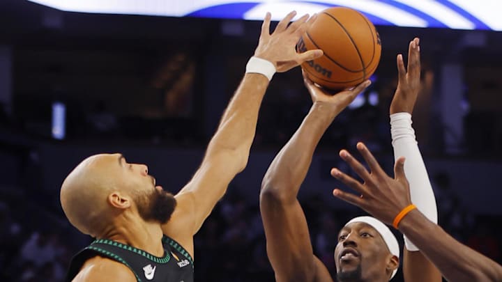 Jan 6, 2026; Minneapolis, Minnesota, USA; Miami Heat center Bam Adebayo (13) shoots against Minnesota Timberwolves center Rudy Gobert (27) in the third quarter at Target Center. Mandatory Credit: Bruce Kluckhohn-Imagn Images