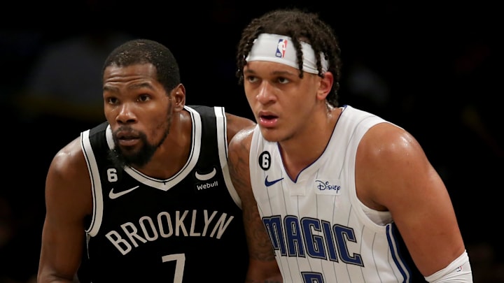 Nov 28, 2022; Brooklyn, New York, USA; Brooklyn Nets forward Kevin Durant (7) and Orlando Magic forward Paolo Banchero (5) fight for position during the fourth quarter at Barclays Center. Mandatory Credit: Brad Penner-Imagn Images