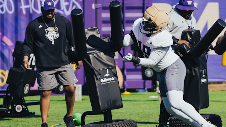 Caleb Smith works through a blocking-dummy drill in UW spring ball.