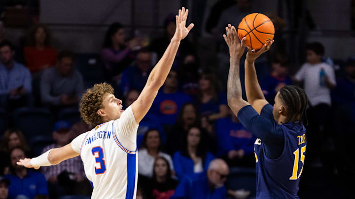 Dec 30, 2023; Gainesville, Florida, USA; Florida Gators center Micah Handlogten (3) attempts to block Quinnipiac forward Amarri Tice (15).
