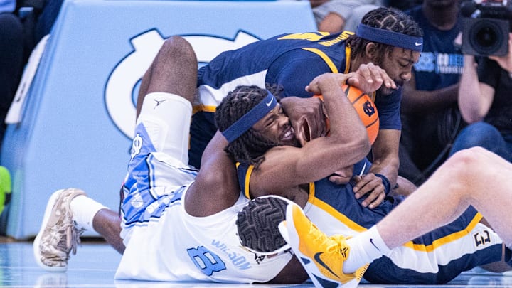 Dec 16, 2025; Chapel Hill, North Carolina, USA; North Carolina Tar Heels forward Caleb Wilson (8) and ETSU Buccaneers guard Jaylen Smith (4) fight for the ball during the first half at Dean E. Smith Center. Mandatory Credit: Scott Kinser-Imagn Images Dec 16, 2025; Chapel Hill, North Carolina, USA; North Carolina Tar Heels forward Caleb Wilson (8) and ETSU Buccaneers guard Jaylen Smith (4) fight for the ball during the first half at Dean E. Smith Center. Mandatory Credit: Scott Kinser-Imagn Images