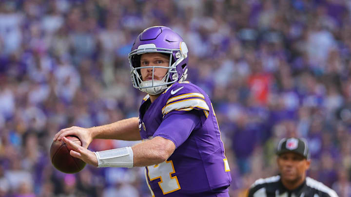 Sep 22, 2024; Minneapolis, Minnesota, USA; Minnesota Vikings quarterback Sam Darnold (14) throws a pass for a touchdown against the Houston Texans in the first quarter at U.S. Bank Stadium. Mandatory Credit: Brad Rempel-Imagn Images