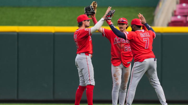 Apr 12, 2026; Cincinnati, Ohio, USA;  Los Angeles Angels outfielder Josh Lowe (3), outfielder Bryce Teodosio (22), and outfielder Jo Adell (7) celebrate defeating the Cincinnati Reds at Great American Ball Park. Mandatory Credit: Aaron Doster-Imagn Images