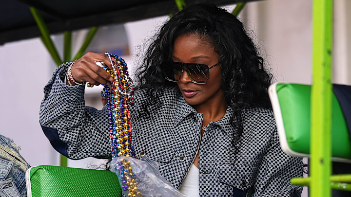 Loreal Sarkisian, wife of Texas Longhorns head coach Steve Sarkisian, opens a bag of beads ahead of the Sugar Bowl Second-Line Parade on Friday, Dec. 29, 2023 in New Orleans, Louisiana. The Texas Longhorns will face the Washington Huskies in the Sugar Bowl on January 1, 2024.