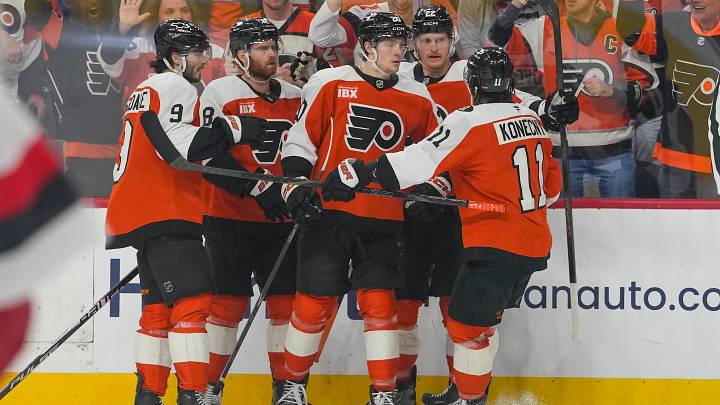 May 9, 2026; Philadelphia, Pennsylvania, USA; Philadelphia Flyers left wing Alex Bump (20) celebrates a goal with teammates against the Carolina Hurricanes in game four of the second round of the 2026 Stanley Cup Playoffs at Xfinity Mobile Arena.