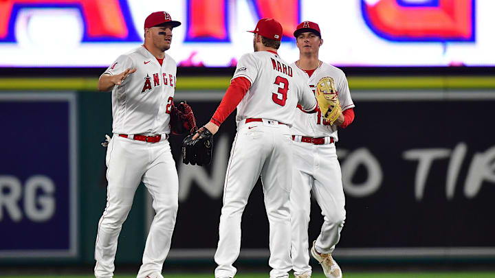 Jun 9, 2023; Anaheim, California, USA; Los Angeles Angels center fielder Mike Trout (27) left fielder Taylor Ward (3) and right fielder Mickey Moniak (16) the victory against the Seattle Mariners at Angel Stadium. Mandatory Credit: Gary A. Vasquez-Imagn Images