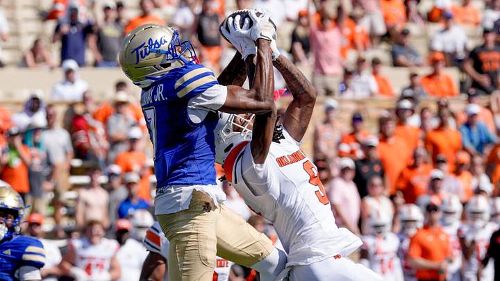 Tulsa wide receiver Jimmy Calloway (7) catches a pass over Oklahoma State cornerback LaDainian Fields. Tulsa wide receiver Jimmy Calloway (7) catches a pass over Oklahoma State cornerback LaDainian Fields.