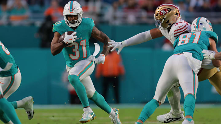 Miami Dolphins running back Raheem Mostert (31) runs with the football past San Francisco 49ers defensive end Yetur Gross-Matos (94) during the second quarter at Hard Rock Stadium. 