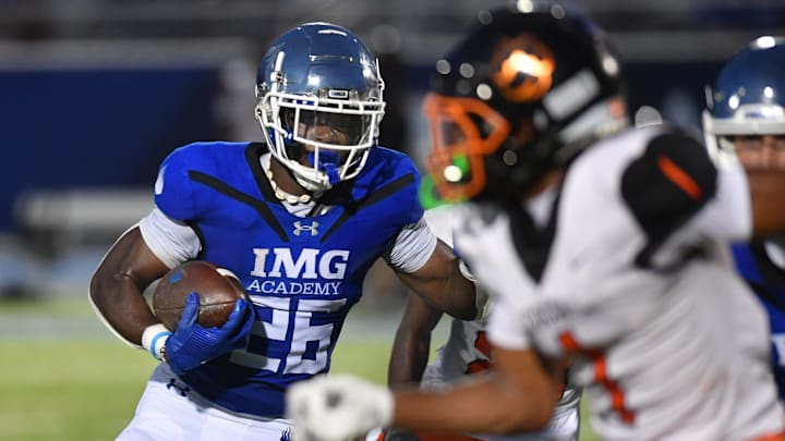 IMG Academy running back Donovan Johnson (#26) weaves his way through Cocoa High defenders on his way to the end zone in the second quarter. The IMG Academy National squad hosted the Cocoa High School Tigers Friday, Sept. 6, 2024 in Bradenton.