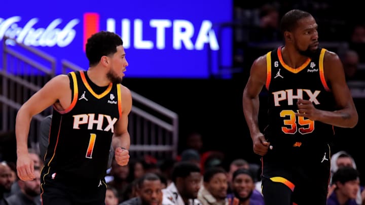 Dec 27, 2023; Houston, Texas, USA; Phoenix Suns guard Devin Booker (1) and Phoenix Suns forward Kevin Durant (35) react after a made basket against the Houston Rockets during the second quarter at Toyota Center. Mandatory Credit: Erik Williams-Imagn Images