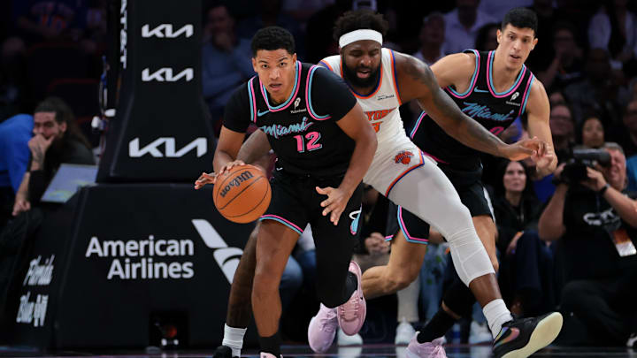 Nov 17, 2025; Miami, Florida, USA; Miami Heat guard Dru Smith (12) dribbles the basketball against New York Knicks center Mitchell Robinson (23) during the first quarter at Kaseya Center. Mandatory Credit: Sam Navarro-Imagn Images Nov 17, 2025; Miami, Florida, USA; Miami Heat guard Dru Smith (12) dribbles the basketball against New York Knicks center Mitchell Robinson (23) during the first quarter at Kaseya Center. Mandatory Credit: Sam Navarro-Imagn Images