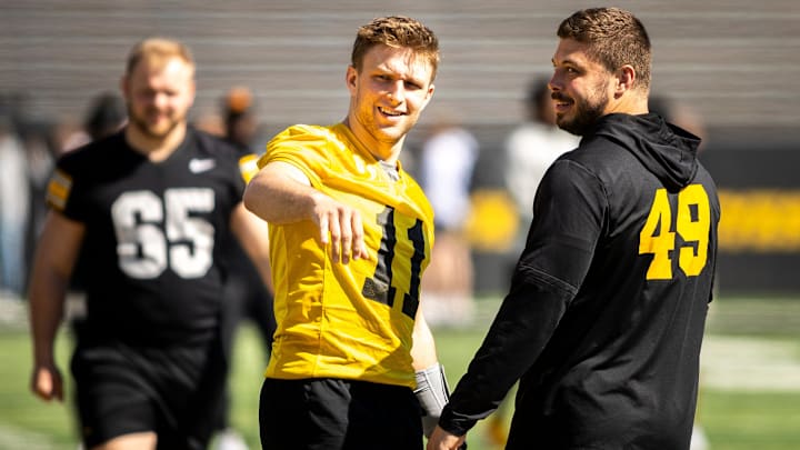 Apr 26, 2025; Iowa City, IA, USA; Iowa quarterback Mark Gronowski (11) talks with defensive lineman Ethan Hurkett (49) during a spring NCAA football open practice at Kinnick Stadium. Mandatory Credit: Joseph Cress/For the Register