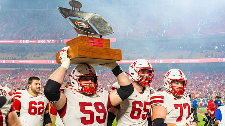 Nebraska offensive lineman Henry Lutovsky hoists the Battle Sports Kansas City Classic trophy after the Huskers' season-opening win against Cincinnati.