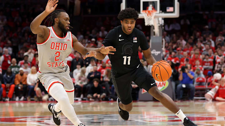 Jan 3, 2025; Columbus, Ohio, USA;  Michigan State Spartans guard Jase Richardson (11) dribbles past Ohio State Buckeyes guard Bruce Thornton (2) during the first half at Value City Arena. Mandatory Credit: Joseph Maiorana-Imagn Images