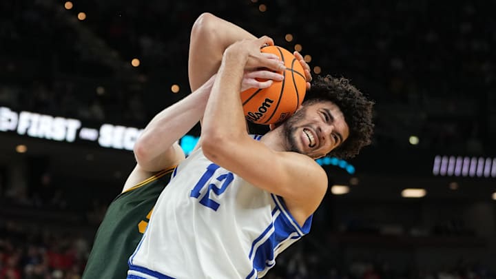 Duke forward Cameron Boozer battles for a rebound with Siena center Riley Mulvey during the first round of the men’s NCAA tournament.