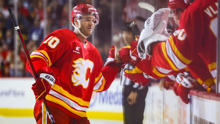 Mar 12, 2025; Calgary, Alberta, CAN; Calgary Flames left wing Jonathan Huberdeau (10) celebrates his goal with teammates during the shootout period against the Vancouver Canucks at Scotiabank Saddledome. Mandatory Credit: Sergei Belski-Imagn Images