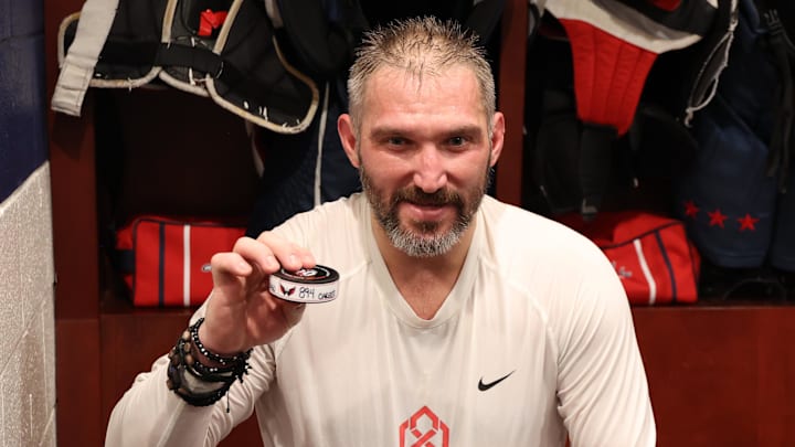 Apr 4, 2025; Washington, District of Columbia, USA; Washington Capitals left wing Alex Ovechkin (8) holds up the puck representing his 894th career goal in the locker room after the game against the Chicago Blackhawks at Capital One Arena. Ovechkin scored the 893rd and 894th goals of his career, tying Wayne Gretzky for most all-time goals in the NHL. Mandatory Credit: Geoff Burke-Imagn Images Apr 4, 2025; Washington, District of Columbia, USA; Washington Capitals left wing Alex Ovechkin (8) holds up the puck representing his 894th career goal in the locker room after the game against the Chicago Blackhawks at Capital One Arena. Ovechkin scored the 893rd and 894th goals of his career, tying Wayne Gretzky for most all-time goals in the NHL. Mandatory Credit: Geoff Burke-Imagn Images