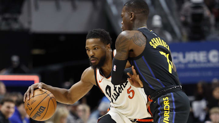 Jan 9, 2025; Detroit, Michigan, USA;  Detroit Pistons guard Malik Beasley (5) dribbles against Golden State Warriors guard Dennis Schroder (71) in the first half at Little Caesars Arena. Mandatory Credit: Rick Osentoski-Imagn Images