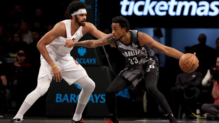 Dec 16, 2024; Brooklyn, New York, USA; Brooklyn Nets center Nic Claxton (33) controls the ball against Cleveland Cavaliers center Jarrett Allen (31) during the first quarter at Barclays Center. Mandatory Credit: Brad Penner-Imagn Images