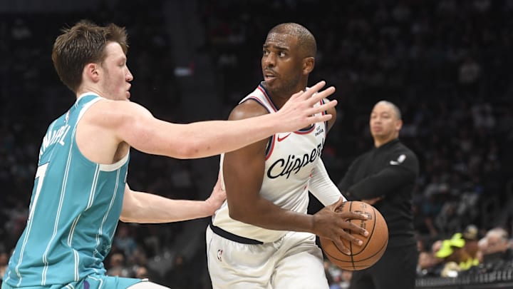 Los Angeles Clippers guard Chris Paul looks to pass as he is defended by Charlotte Hornets guard Koa Knueppel. Los Angeles Clippers guard Chris Paul looks to pass as he is defended by Charlotte Hornets guard Koa Knueppel.