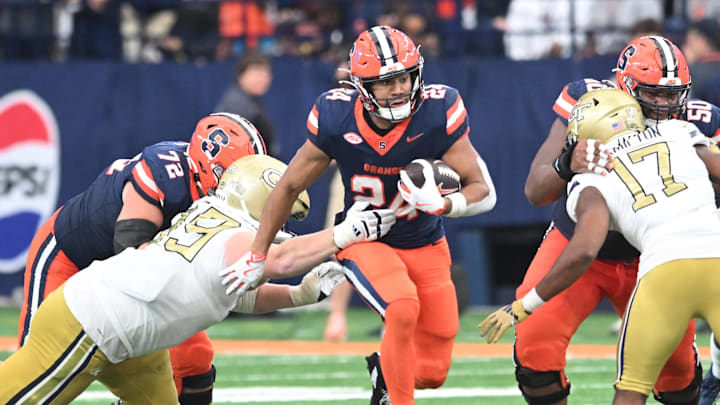 Sep 7, 2024; Syracuse, New York, USA; Syracuse Orange running back Will Nixon (24) runs through a gap in the Georgia Tech Yellow Jackets defense in the third quarter at the JMA Wireless Dome. Mandatory Credit: Mark Konezny-Imagn Images