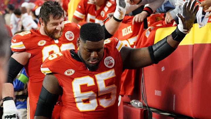 Oct 12, 2023; Kansas City, Missouri, USA; Kansas City Chiefs guard Trey Smith (65) high fives fans after the game against the Denver Broncos at GEHA Field at Arrowhead Stadium. Mandatory Credit: Denny Medley-Imagn Images