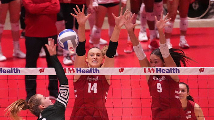Michigan State's Karolina Staniszewska (2) fires a shot at Wisconsin's Anna Smrek (14) and CC Crawford (9) on Saturday, November 30, 2024 at the UW Field House in Madison, Wisconsin.
