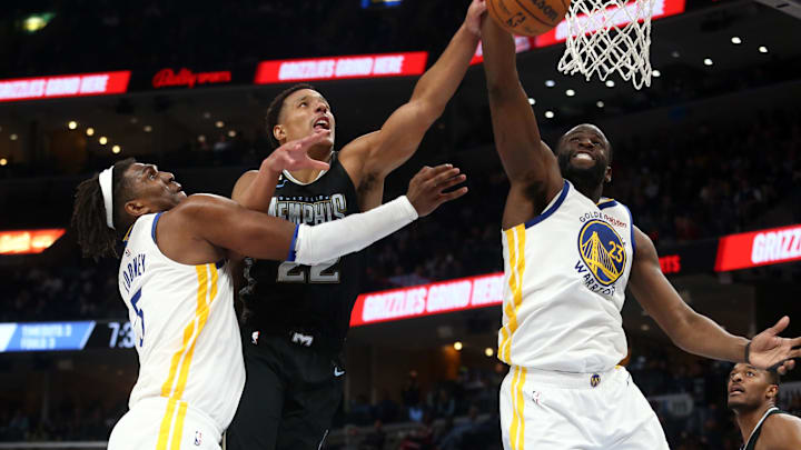 Mar 9, 2023; Memphis, Tennessee, USA; Golden State Warriors forward Kevon Looney (left), forward Draymond Green (right) and Memphis Grizzlies guard Desmond Bane (middle) battle for a rebound during the second half at FedExForum. Mandatory Credit: Petre Thomas-Imagn Images