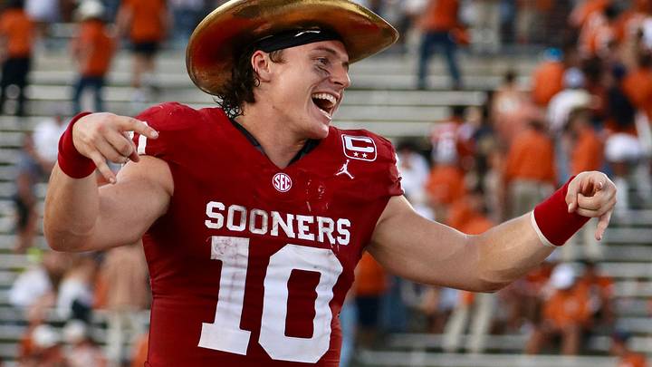 Oklahoma quarterback John Mateer puts the horns down and dons The Golden Hat trophy to celebrate OU's 27-24 victory over the No. 1-ranked Texas Longhorns