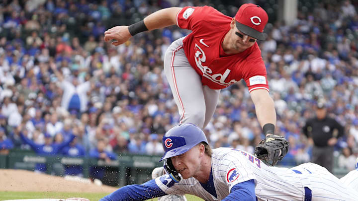 Sep 27, 2024; Chicago, Illinois, USA; Chicago Cubs outfielder Pete Crow-Armstrong (52) is picked off of first base as Cincinnati Reds first baseman Spencer Steer (7) tags him out during the eighth inning at Wrigley Field. Mandatory Credit: David Banks-Imagn Images