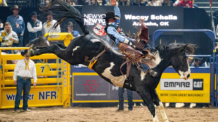 Wacey Schalla and the horse Trooper winning a fourth place check in round three of the bareback riding at the 2025 NFR Wacey Schalla and the horse Trooper winning a fourth place check in round three of the bareback riding at the 2025 NFR