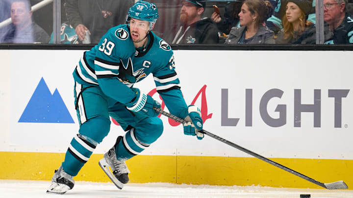 Jan 30, 2024; San Jose, California, USA; San Jose Sharks center Logan Couture (39) plays the puck